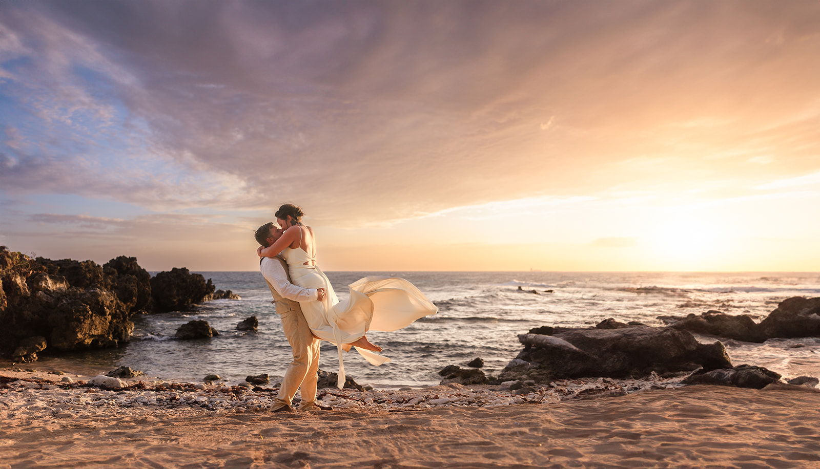 A roatan bride and groom hold each other at sunset at West Bay beach roatan during their Roatan elopement
