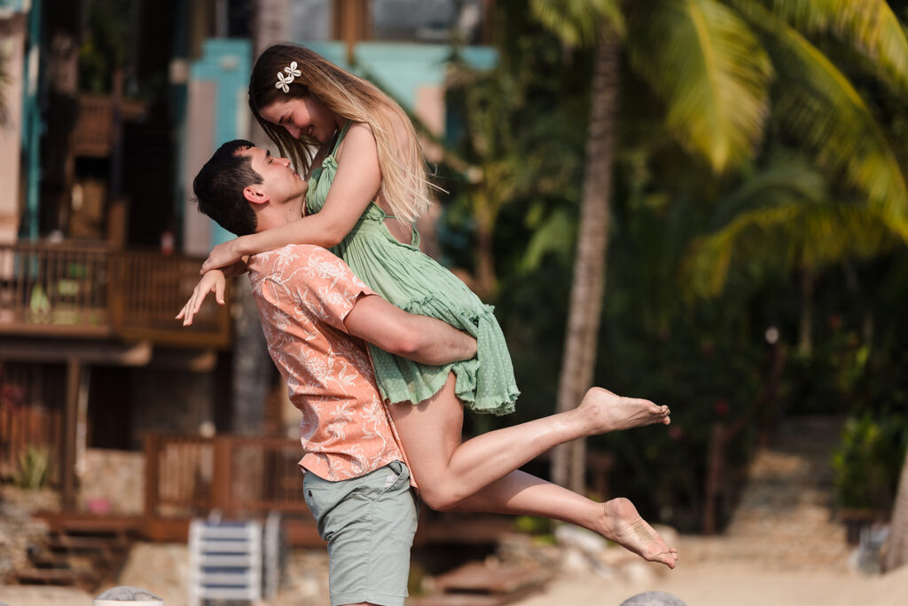 A man lifting a woman and smiling at each other.