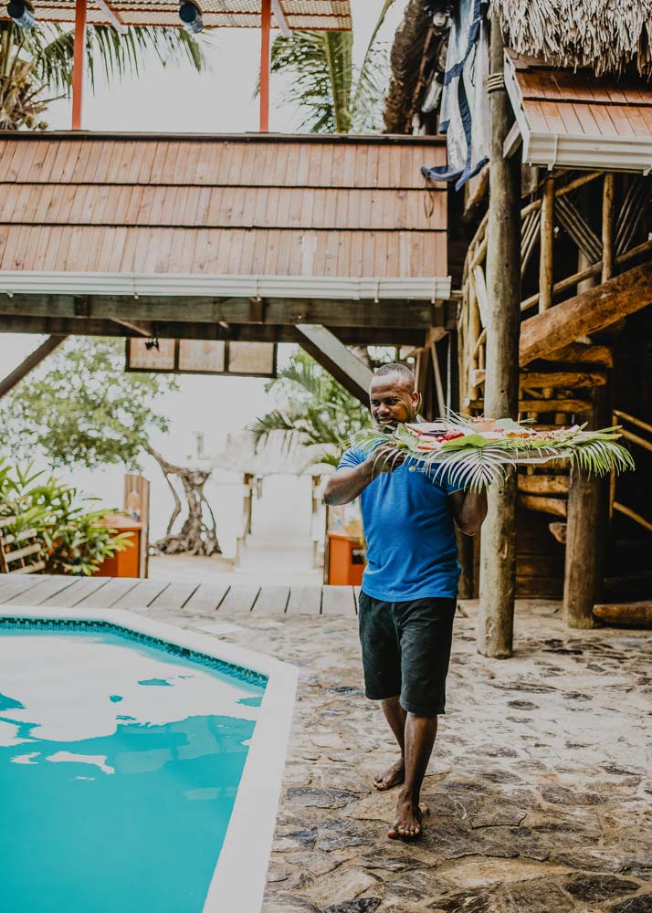 A server bring snacks by the pool at Tranquilseas