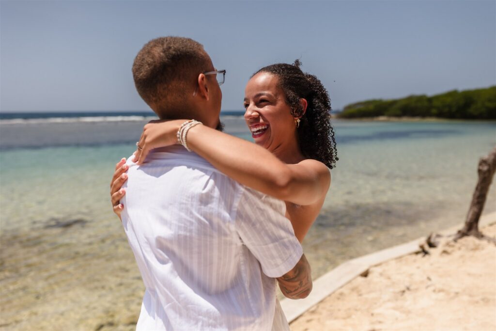 A couple hugs and laughs in Roatan after their Roatan proposal.