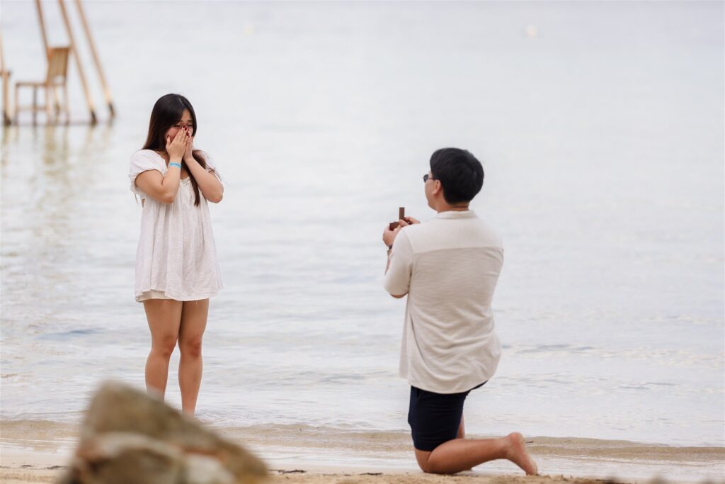 A woman holds back tears while being proposed to in Roatan on the beach.