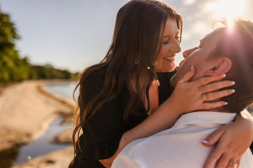 A couple almost kisses at sunset in Roatan after their Roatan proposal.
